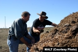 FILE: Jeffrey Creque (L) examines Marin Carbon Project ranch partner Loren Poncia’s (R) compost at the Stemple Creek Ranch before spreading it on the area.