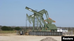 FILE - A pump jack stands in Dewitt County, Texas, January 2016. 