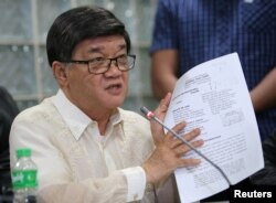 Philippine Justice Minister Vitaliano Aguirre shows the documents filed in the local court against Senator Leila de Lima during a news conference at the National Bureau of Investigation headquarters in metro Manila, Philippines Feb. 17, 2017.