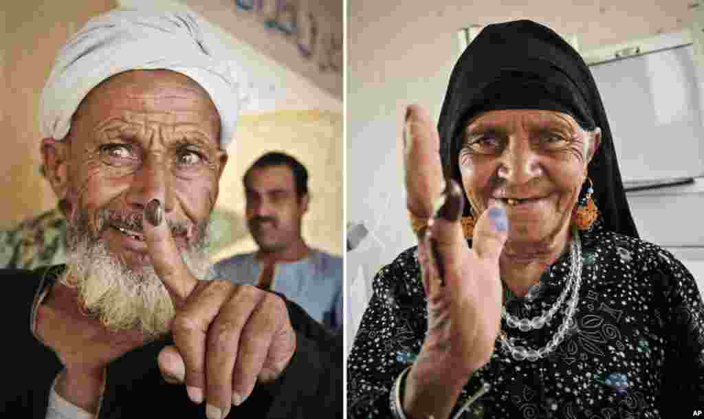 Egyptians show their inked fingers after casting their votes in Giza, Egypt. 