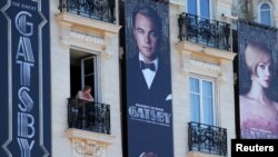 Posters for the film 'The Great Gatsby' showing actor Leonardo DiCaprio (C) and actress Carey Mulligan (R) are displayed outside the Carlton Hotel before the start of the 66th Cannes Film Festival in Cannes, May 13, 2013.