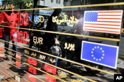 Various currency rates are displayed at a window of an exchange shop in downtown Tehran, Iran, Sept. 5, 2018.