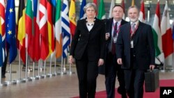 British Prime Minister Theresa May, left, arrives for an EU summit at the Europa building in Brussels, March 23, 2018.