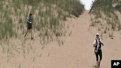 Pam Riehl Szakal and Sue Segel trek through the sand dunes during the Stark Raving Mad adventure race.