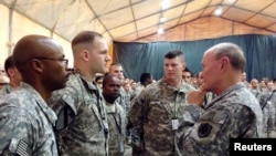 General Martin Dempsey, right, chairman of the Joint Chiefs of Staff, speaks to U.S. troops at Baghdad International Airport in Iraq, Nov. 15, 2014. 