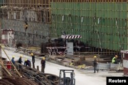 Chinese workers are seen at the construction site of the new Great Mosque, which is being built by the China State Construction Engineering Corporation (CSCEC), in Algiers, Algeria, Jan. 20, 2016.