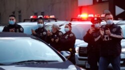 New York City Police clap and cheer for healthcare workers in Manhattan at 7pm during the outbreak of the coronavirus disease (COVID-19) in New York City