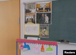 Pictures of the Japanese imperial family are displayed on a blackboard in a classroom at Tsukamoto kindergarten in Osaka, Japan, Nov. 30, 2016.