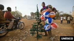Street vendor in Juba, South Sudan, selling plastic Christmas trees and inflatable balls made in China. (Photo: UNESCO/Sven Torfinn/Panos)