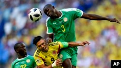 Le Sénégalais Kalidou Koulibaly (à droite) et son co-equipier Youssouf Sabaly (à gauche) sautent pour contrer le Colombien Radamel Falcao lors du match du groupe H entre le Sénégal et la Colombie lors de la Coupe du monde de football 2018 à Samara Arena à