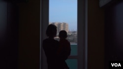 A woman holding a child in Baku, Azerbaijan. (Ulviyya Guliyeva/VOA)