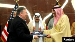 U.S. Secretary of State Mike Pompeo and Kuwait's Foreign Minister Sheikh Sabah Al-Khalid Al-Sabah exchange the signed document in Kuwait City, Kuwait, March 20, 2019. 