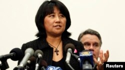 FILE - Chai Ling, a former student leader during the Tiananmen Square protests, speaks as U.S. Representative Chris Smith (R-NJ) stands behind her during a news conference on Capitol Hill in Washington, January 18, 2011.