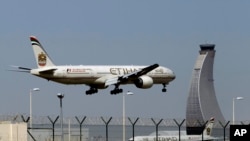 FILE - An Etihad Airways plane prepares to land at the Abu Dhabi airport in the United Arab Emirates, May 4, 2014.