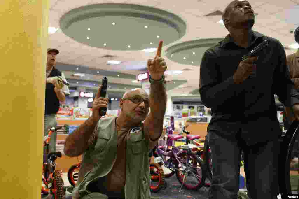 Security officers secure an area inside Westgate Shopping Center in Nairobi September 21, 2013.