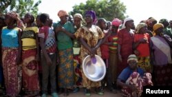 FILE - Women stand in line for food aid in the village of Makunzi Wali, Central African Republic.