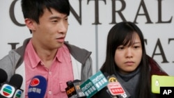 Pro-democracy lawmakers Sixtus Leung, left, and Yau Wai-ching speak to the media outside a police station after being released on bail in Hong Kong, April 26, 2017.