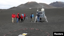 Scientists from German Aerospace Center are seen working as they test some robots on the Mount Etna, Italy, July 2, 2017. 