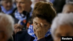Survivor Maria Stroinska reacts as she attends a ceremony at the former Nazi German concentration and extermination camp Auschwitz-Birkenau near Oswiecim, Poland, Jan. 27, 2016.