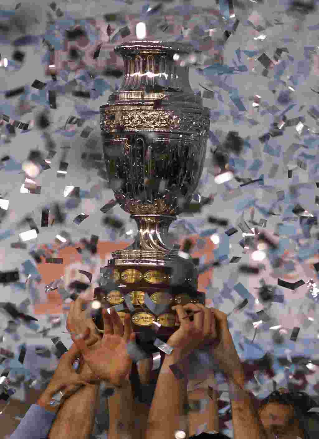 Uruguay's players hold the Copa America while celebrating at the end of the final soccer match with Paraguay in Buenos Aires, Argentina, Sunday, July 24, 2011. Uruguay won the Copa America for a record 15th time after beating Paraguay 3-0 with two goals s