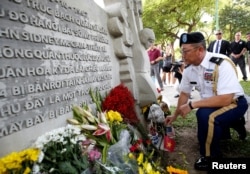 Military Attache Ton Tuan from U.S. Embassy places incense while he pays respect in memory of the late U.S. Senator John McCain (R-AZ) at the McCain Memorial in Hanoi, Vietnam, Aug. 27, 2018.