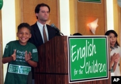 Jose Antonio Gonzalez, 10, left, cheers with other children as Proposition 227 writer Ron Unz addresses the media and supporters of the proposal to end bilingual education in the state, in Los Angeles Tuesday, June 2, 1998.