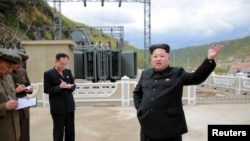 FILE - North Korean leader Kim Jong Un (R) gives field guidance during a visit to a construction site.