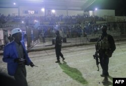 Somali security forces patrol during the soccer match between the Hodan and Waberi districts at Konis Stadium, renovated by FIFA, in Modadishu, Somalia, Sept. 8, 2017. It was the city's first night game in 30 years.