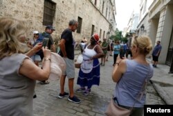 Lyssett Perez, 46 (C), sells peanuts to tourists on the streets in Havana, Cuba, September 6, 2018.