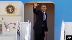 President Barack Obama waves prior to boarding Air Force One before departing form Andrews Air Force Base in Maryland, March. 15, 2013.