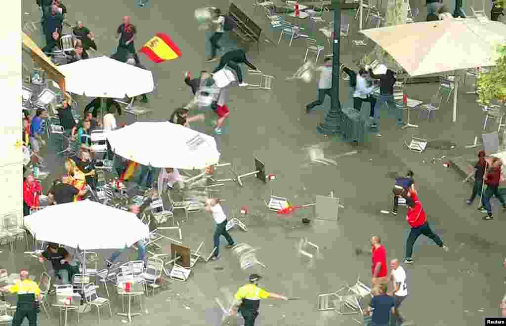 A small group of protesters clash on the fringes of a demonstration in Barcelona, Spain.