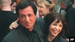 FILE - Sylvester Stallone poses with "Rocky" co-star Talia Shire before a screening of the film to celebrate its 20th anniversary, Nov. 15, 1996, at the Academy of Motion Picture Arts & Sciences.