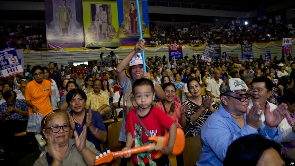 A child plays a toy guitar during a rally ahead of a general election in Bangkok, March 22, 2019. The nation's first general election since the military seized power in a 2014 coup is scheduled to be held March 24.