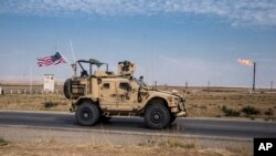 In this Monday, Oct. 28, 2019 photo, U.S. forces patrol Syrian oil fields. Pentagon is increasing U.S. efforts to protect Syria's oil fields from the extremist group as well as from Syria itself and the country's Russian allies