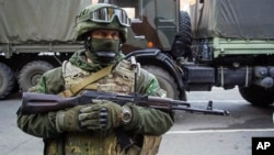 FILE - A pro-Russia rebel stands guard in Donetsk, eastern Ukraine, Oct. 29, 2015.