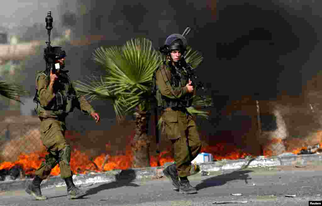 Israeli soldiers are seen during clashes with Palestinian protesters in the West Bank town of Al-Ram, near Jerusalem.