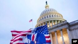FILE - A flag depicting President Donald Trump flies on the East Front of the US Capitol on Jan. 6, 2021, in Washington.