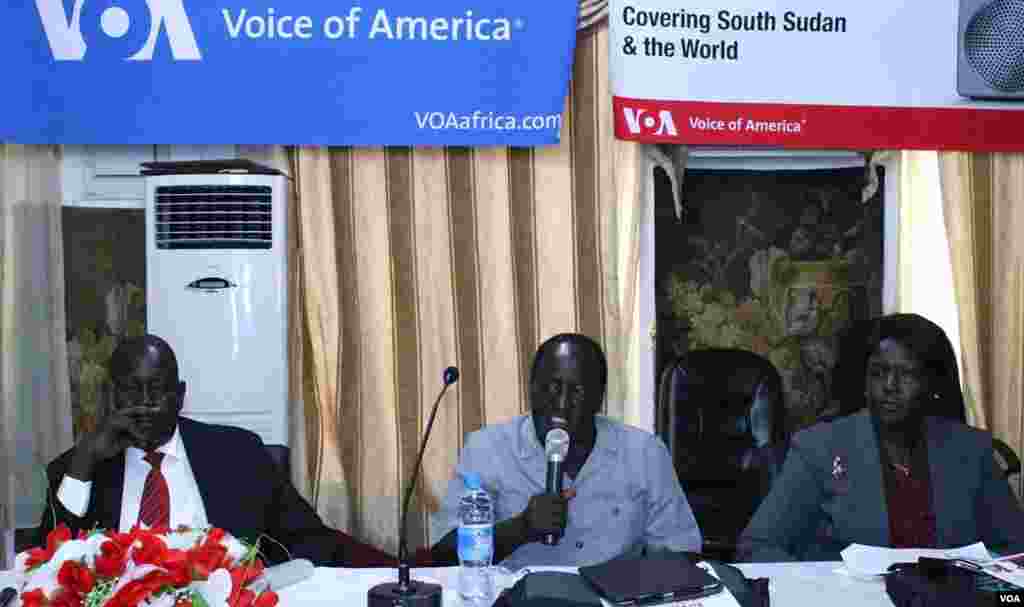 Chuol Rambang, chair of South Sudan's Peace and Reconciliation Commission (l) and Jehan Deng, Minister of Health and Environment in Jonglei state, listen as fellow panelist at the Voice of America town hall meeting in Juba, Alfred Sebit Lokuji, speaks. 