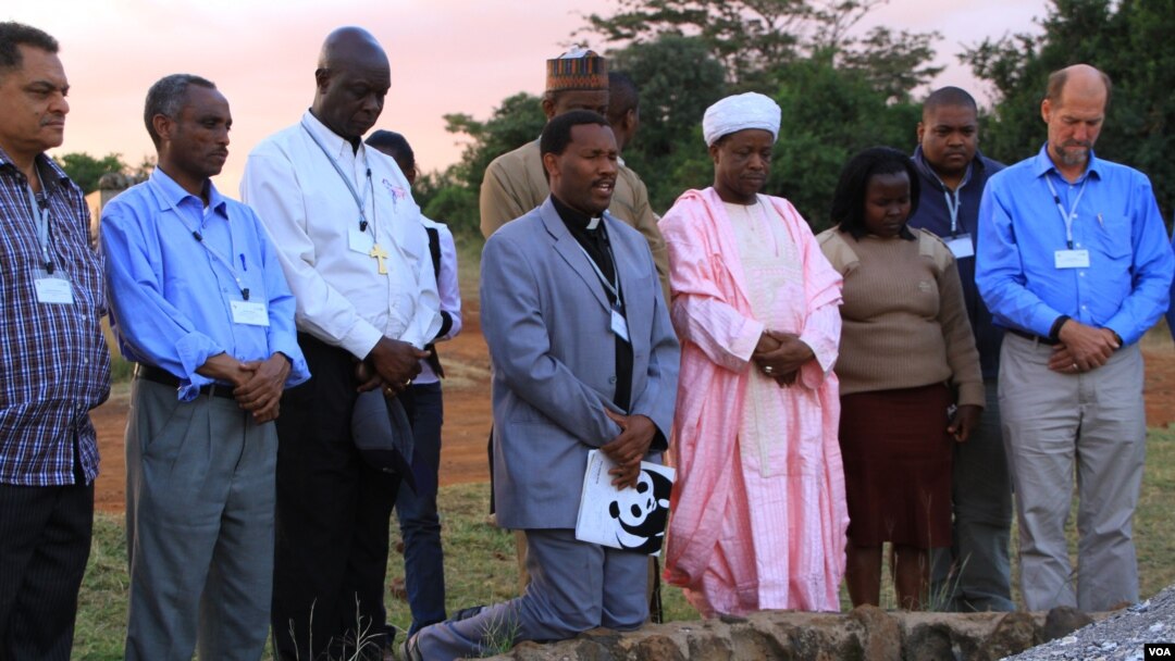 Representatives of the Christian, Muslim, Hindu, and Buddhist faiths pray for Africa's wildlife at the historic Ivory Burning Site in Nairobi National Park, Kenya, September 20, 2012. (J. Craig/VOA)