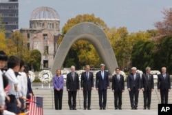 Secretary of State John Kerry joins other leaders and Japan's Foreign Minister Fumio Kishida at the Hiroshima Peace Memorial Park on April 11, 2016.