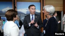 Canada's Minister of Finance Bill Morneau speaks to CEO of the World Bank Kristalina Georgieva and Managing Director of the International Monetary Fund Christine Lagarde, right, as he wears a G-7 Summit pin, in Whistler, British Columbia, Canada, May 31, 2018. 