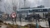 Indian paramilitary soldiers stand by the wreckage of a bus after an explosion in Pampore, Indian-controlled Kashmir, Feb. 14, 2019. 