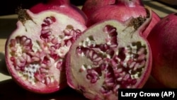 This file photo taken Sept. 3, 3009 shows sliced pomegranate. The ruby red fruit, which resembles a large apple but only its seeds are edible, is in season in September. (AP Photo/Larry Crowe)
