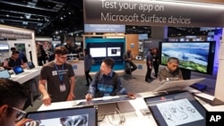 Workers demonstrate Microsoft devices at the Microsoft Build 2017 developers conference in Seattle, May 10, 2017. 