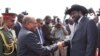 Sudanese President Omar al Bashir is greeted as he arrives in Juba for a historic visit on Friday, April 12, 2013 with a handshake by his South Sudanese counterpart Salva Kiir. as 
