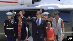 President Barack Obama, first lady Michelle Obama and their daughters Malia and Sasha, prior to departing San Salvador, El Salvador, Wednesday, March 23, 2011. (AP Photo/Pablo Martinez Monsivais)
