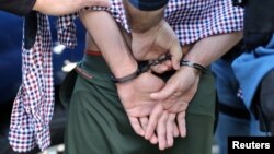FILE - U.S. Immigration and Customs Enforcement agents arrest an immigrant in San Clemente, California, May 11, 2017. 