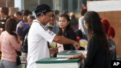 A local resident casts his ballot for the general election at a polling station in Bangkok, Thailand, Sunday, Feb. 2, 2014.