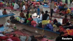 Villagers rest at a temporary evacuation center for people living near Mount Agung, a volcano on the highest alert level, inside a sports arena in Klungkung, on the resort island of Bali, Indonesia, Sept. 28, 2017, in this photo taken by Antara Foto.
