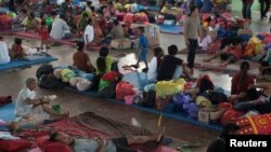 Villagers rest at a temporary evacuation center for people living near Mount Agung, a volcano on the highest alert level, inside a sports arena in Klungkung, on the resort island of Bali, Indonesia, Sept. 28, 2017, in this photo taken by Antara Foto.